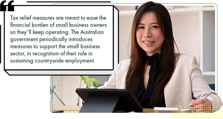 An Australian businesswoman smiling and understanding the tax relief and company tax rate Australia offers.